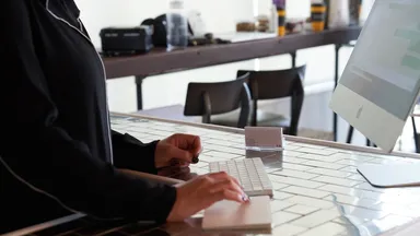 A woman using a computer at the front desk